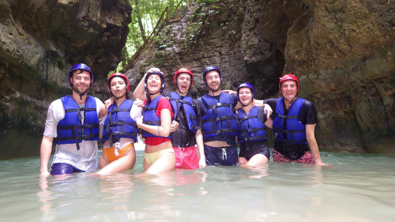 A group of happy vacationers at the end of their excursion to the 27 waterfalls at Damajagua with Cocotours